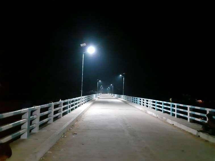 The same bridge at night, lit by the solar street lights