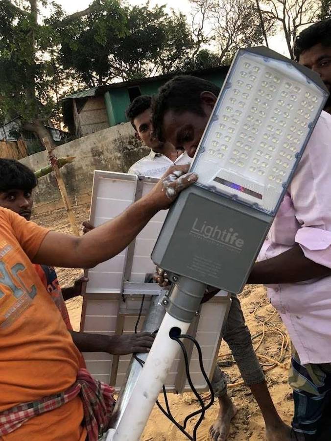 Technicians assembling a Lightife LED street light head in Rangamati